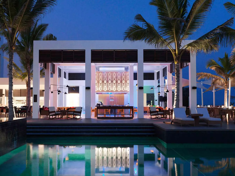 Relax by the pool at Al Baleed Resort Salalah by Anantara during luxury holidays to Oman