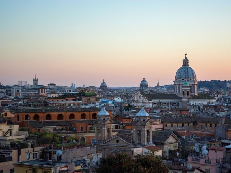 Witness Rome’s ancient rooftops and domes at sundown