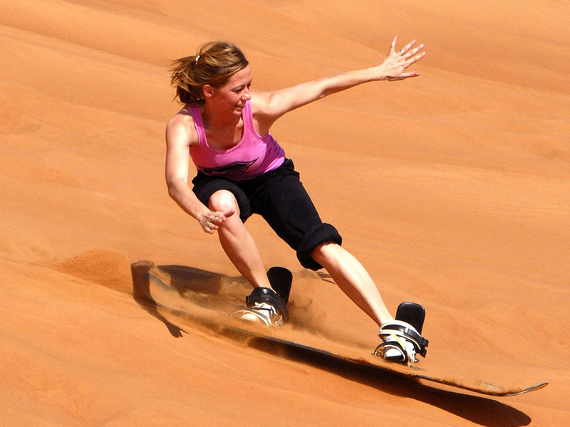 Enjoy a sand boarding lesson in the Atlantis Dunes during your luxury African holiday