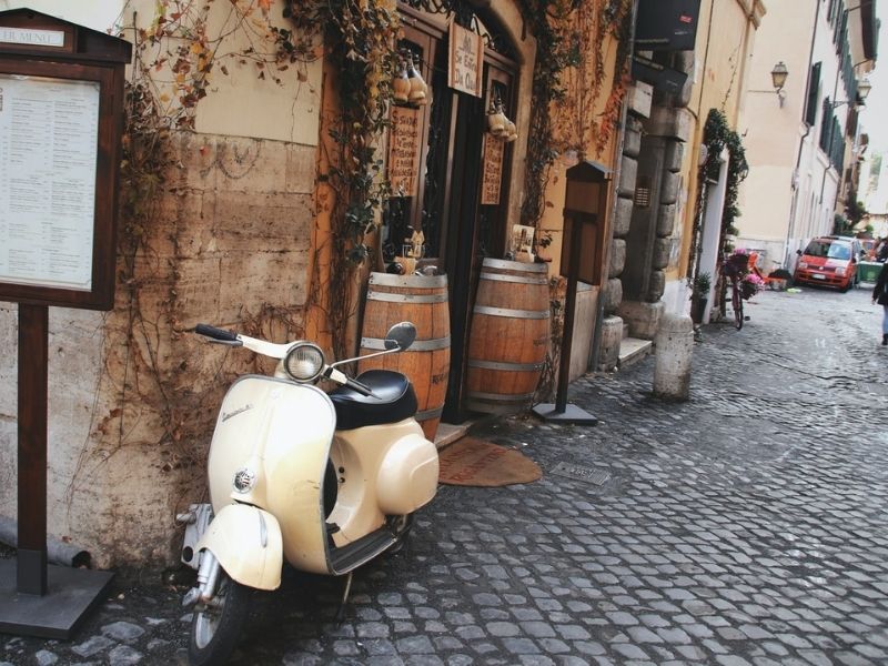 Zip through the bustling streets of Rome on a Vespa
