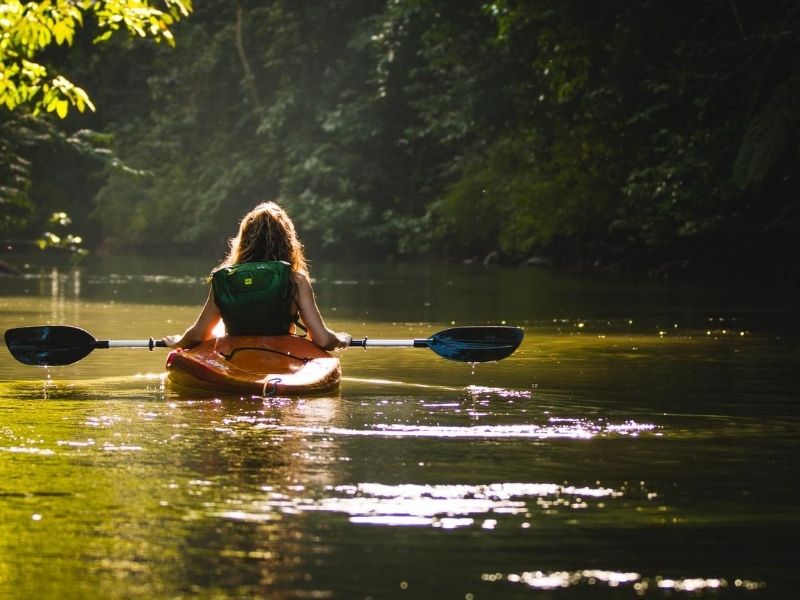 Woman kayaking on lake